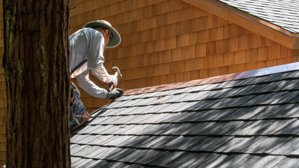 Roofing specialist performing preventative maintenance by sealing roof penetrations