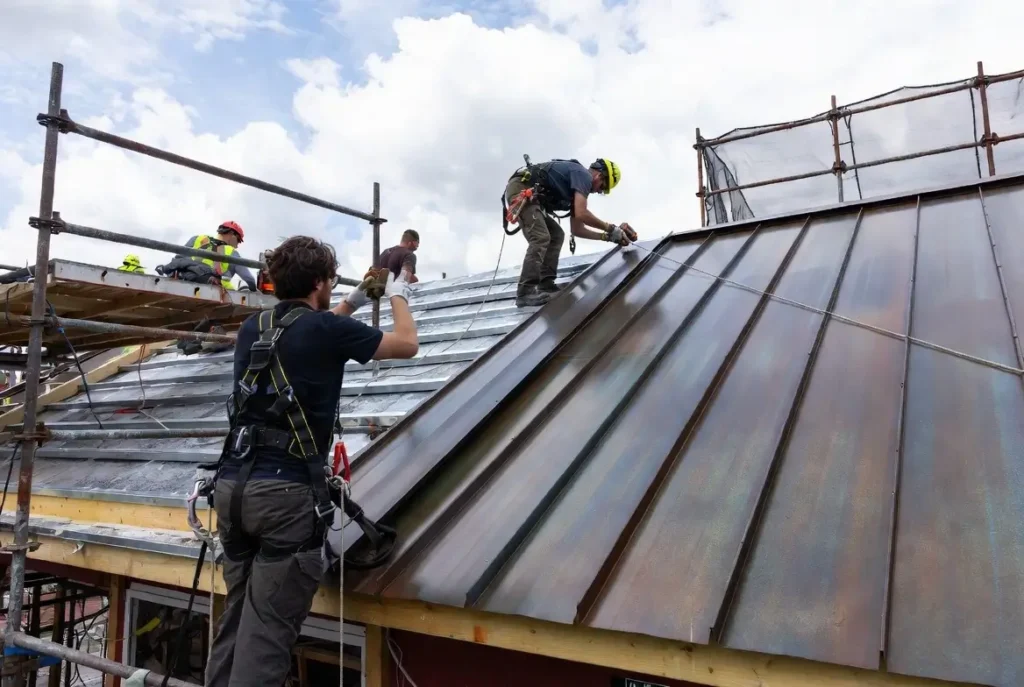 Professional crew installing metal roofing on Greater Atlanta home showing specialized installation requirements